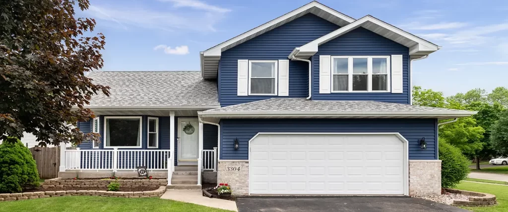 Two-story suburban home with navy blue siding and white trim