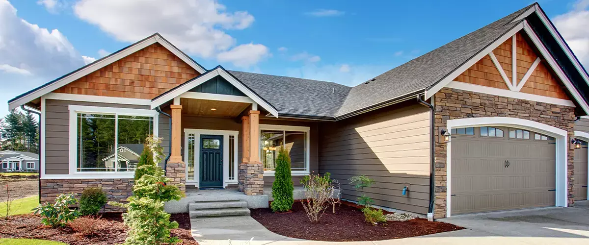 Completed custom home with stone accents and landscaped front yard