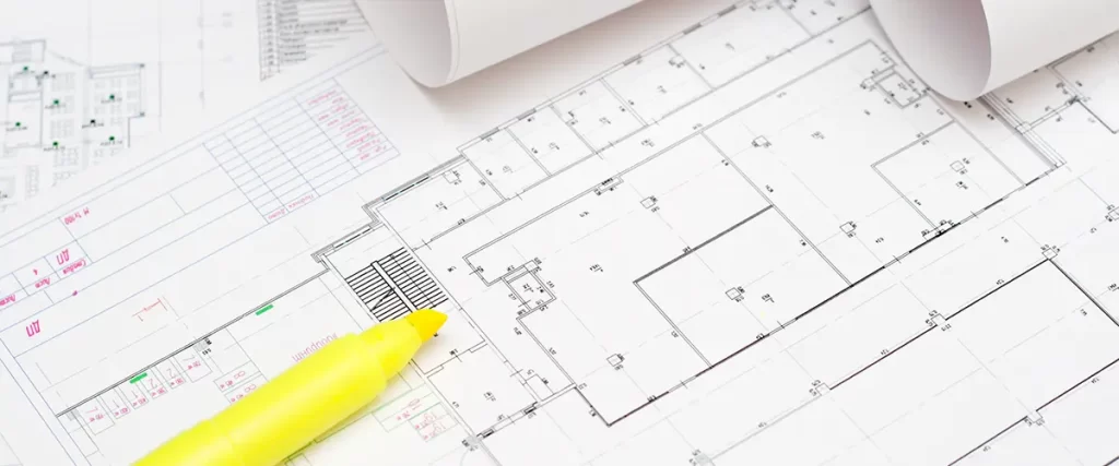 Close-up of architectural floor plans with yellow highlighter